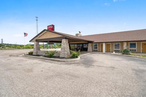 a gas station with a sign on top of it at OYO Hotel Junction TX I-10 in Junction