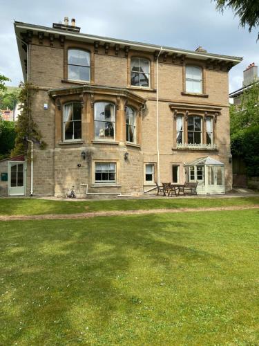 a large brick house with a bench in front of it at Garden View in Great Malvern