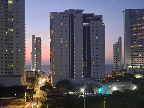 a city skyline with tall buildings at night at Aqualina 911 in Cartagena de Indias