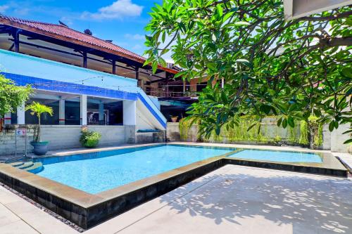 a swimming pool in front of a house at Townhouse Oak Legian Near Legian Beach Formerly Sayang Maha Merta in Legian