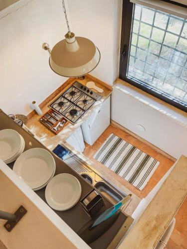 a small kitchen with a stove and a sink at Pietra Pizzuta Country House in Torre deʼ Passeri