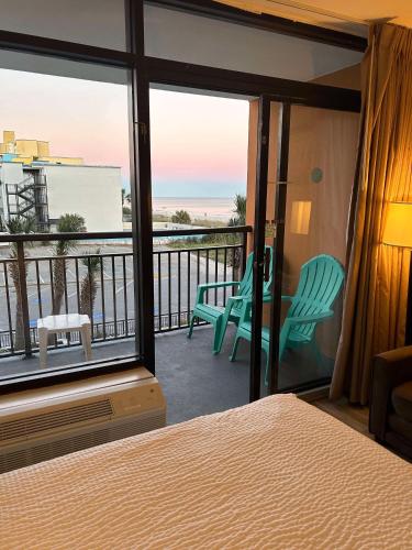 a bedroom with a bed and a view of the ocean at Ocean View 2 Queen Studio at Landmark Resort in Myrtle Beach