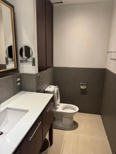 a bathroom with a toilet and a sink at XX Wish Inn Silom BKK - วิช อินน์ สีลม in Bang Rak
