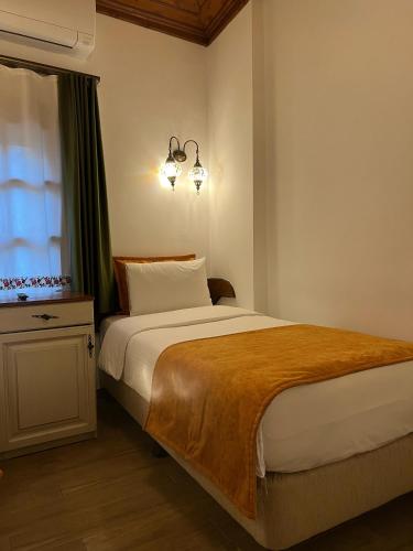 a bedroom with a large bed and a window at White Garden Hotel-Adult Only in Antalya