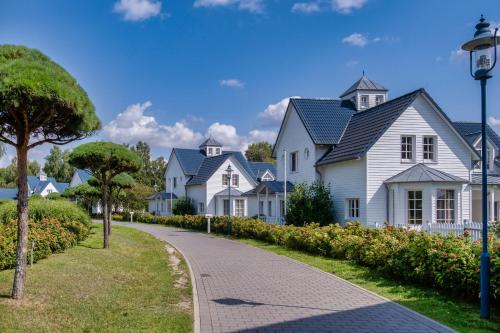 a row of white houses on a street at Precise Resort Schwielowsee - Apartments in Werder