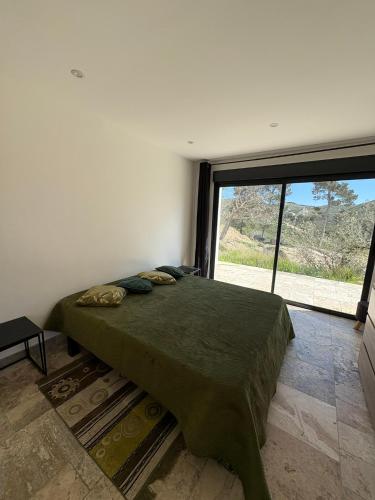 une chambre avec un lit avec une grande fenêtre dans l'établissement Le Cassiopée, à Ensuès-la-Redonne
