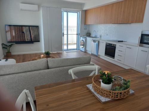 a living room with a couch and a table at Lillian Waters Retreat in Yamba
