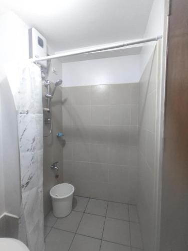 a bathroom with a shower and a toilet in it at Harmony Condo 620 in Mandaue City