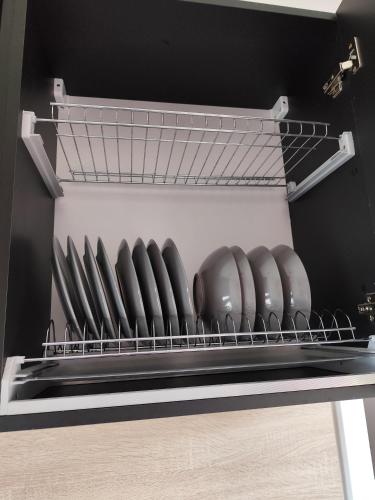 a shelf in a refrigerator with a row of bowls at Little Tiny Village Haus 3 in Fußach