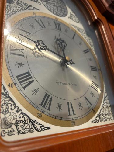 a close up of a clock with roman numerals at Crescent Hotel in Reading