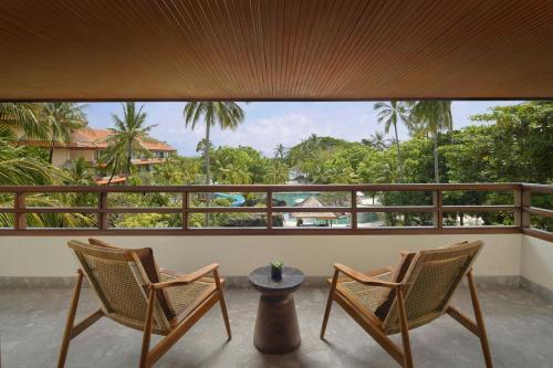 two chairs and a table on a balcony with a view at The Westin Resort Nusa Dua, Bali in Nusa Dua