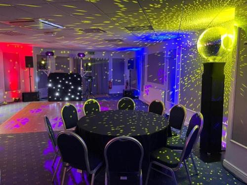 a room with a table and chairs and lights at Dancenter East Midlands Airport in Derby