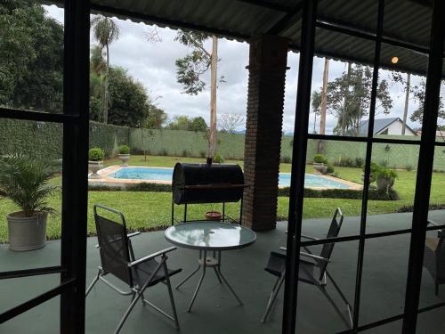 a patio with a table and chairs and a pool at Colonial-style house in Villarrica