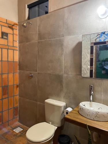 a bathroom with a toilet and a sink at Colonial-style house in Villarrica