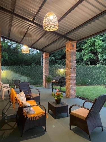 an outdoor patio with chairs and tables and a ceiling at Colonial-style house in Villarrica