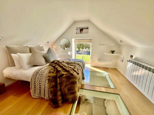 a room with a bed and a glass table at Little Barn Peak District in Leek