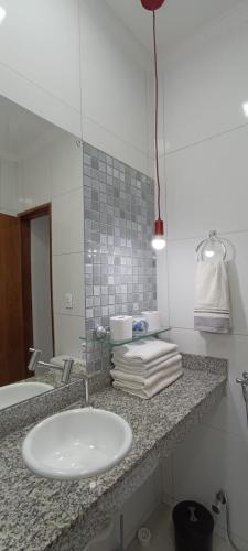 a bathroom counter with a sink and a mirror at Casa Marzenta in Petrolina