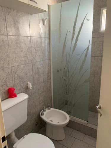 a bathroom with a toilet and a glass shower at La China in Neuquén