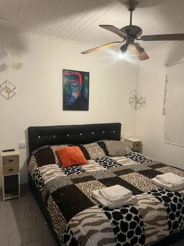 a bedroom with a bed and a ceiling fan at La China in Neuquén