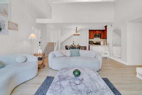 a white living room with a couch and a table at High Ceilings 3BR with Loft-2 Baths Pool & Jacuzzi in Tarzana