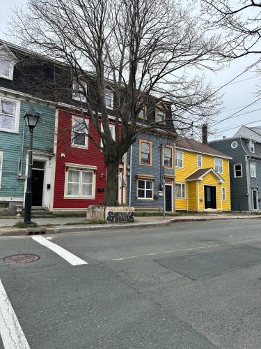 a row of colorful houses on a city street at Colorful Charm Jellybean 3BR House In St John's in St. John's