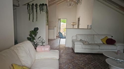 a living room with two white couches in a room at הזהר הצפוני in Rosh Pinna