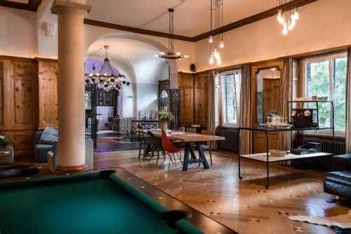 a living room with a pool table in it at Kurhaus Lenzerheide in Lenzerheide