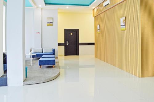 a hallway with a door and chairs in a hospital at Collection O Balikpapan Near Balikpapan Super Block Formerly City Inn Hotel in Balikpapan