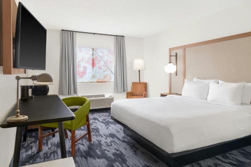 a hotel room with a bed and a desk at Fairfield Inn & Suites Saginaw in Saginaw
