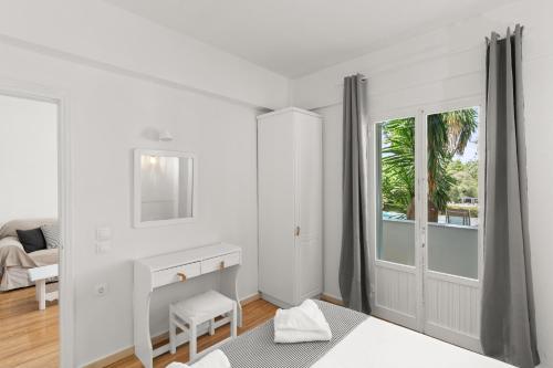 a white room with a fireplace and a window at Mr and Mrs White Corfu Couples Retreat Adults Only in Acharavi