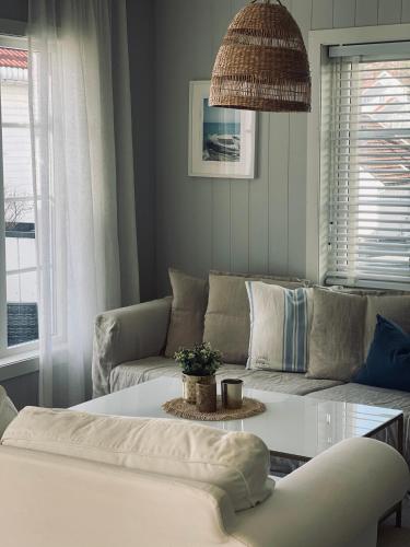 a living room with a couch and a table at No7 Risør in Risør