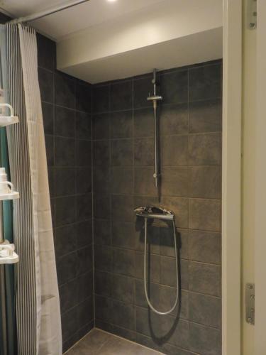 a bathroom with a shower with a shower curtain at close to norreport st & central 302 - norregade 34a 3 kobenhavn 1165 in Århus Østbanegård
