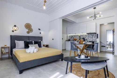 a bedroom with a king sized bed and a kitchen at VRACHOS HOUSE "In the heart of Skopelos Town" in Skopelos Town