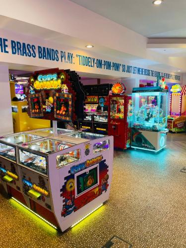 a room with two arcade games and a game brawl lanes at Luxury Cozy Caravan at Seaton Sands in Port Seton