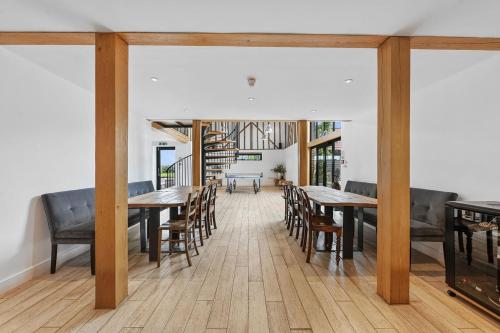 a dining room with wooden tables and chairs at The Hare's Field, Wethersfield in Wethersfield