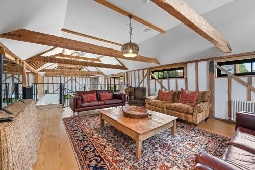 a living room with couches and a table at The Hare's Field, Wethersfield in Wethersfield