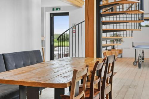 a wooden table and chairs in a room at The Hare's Field, Wethersfield in Wethersfield