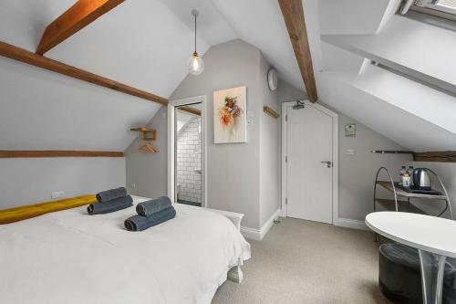 a bedroom with a white bed and a table at The Hare's Field, Wethersfield in Wethersfield