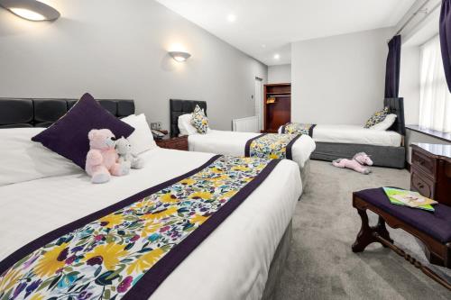 a bedroom with two beds with teddy bears on them at Rathkeale House Hotel in Limerick