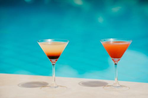 two cocktails in glasses sitting on a table at Mr and Mrs White Corfu Couples Retreat Adults Only in Acharavi