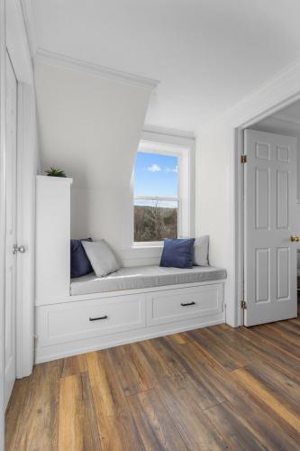 a white room with a bench in a window at Historic 3br W Modern Comforts In Holyrood in Holyrood