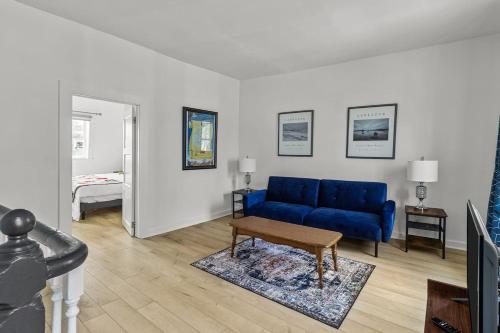 a living room with a blue couch and a table at Colorful Charm Jellybean 3BR House In St John's in St. John's