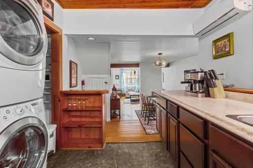 a kitchen with a washer and dryer on a counter at Colorful Charm Jellybean 3br House In St John's in St. John's