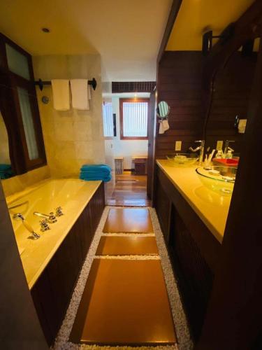 a bathroom with two sinks and a tub at Hidden Paradise Private Villa 3, Langkawi in Teluk Datai