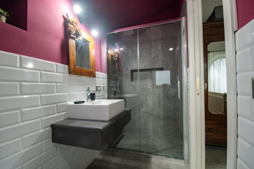 a bathroom with a sink and a glass shower at Agriturismo Re Tarquinio in Tuscania