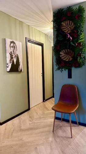 a chair sitting in a room with a mirror at Luksuriøs designleilighet i hjertet av Sandefjord - My Space AS in Sandefjord