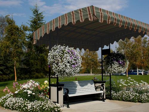 a park bench under a pavilion with flowers at Bear Lodge in Fairbanks