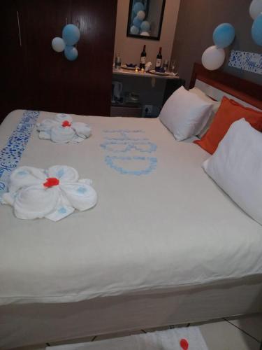 a bed with two towels on top of it at Grand Central Guesthouse in Rustenburg
