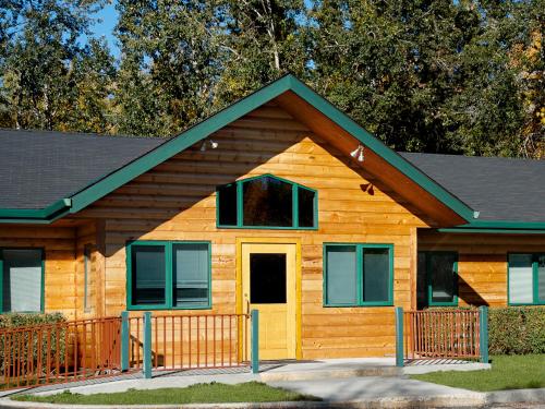a log home with a yellow door at Bear Lodge in Fairbanks
