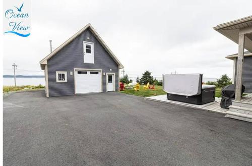 a house with a garage and a truck parked in a driveway at Scenic Seal Cove Nature Retreat Hot Tubatv Trail in Holyrood
